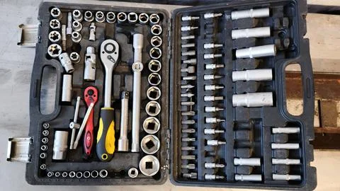 Tool set with socket heads, ratchet and screwdriver bits arranged in case. Fotos Stock