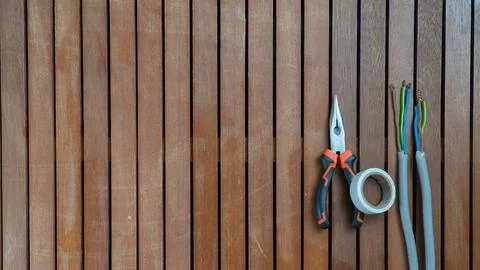Tool set - wire cutters, wire, insulating tape on a wooden background Stock Photos