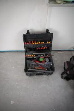 Toolbox stands on the floor of a construction site Stock Photos