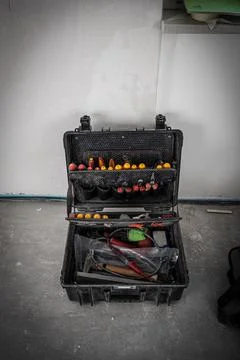 Toolbox stands on the floor of a construction site Stock Photos