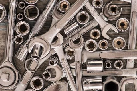 Tools, adjustable wrench, socket wrench, Sockets on wood background, top view Stock Photos