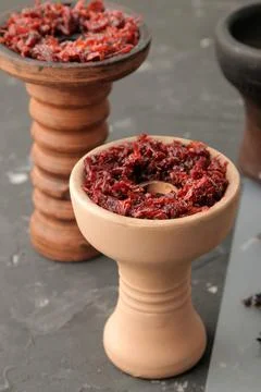 Tools and accessories for making hookah, clay bowls with tobacco on a black b Stock Photos