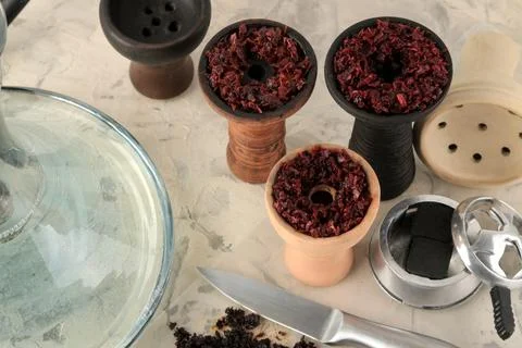 Tools and accessories for making hookah, clay bowls with tobacco, coconut cha Stock Photos