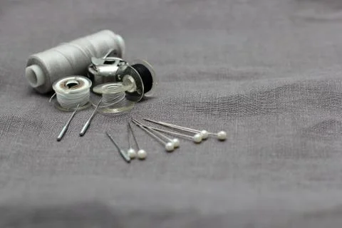 Tools and accessories for sewing on a background of linen fabric Stock Photos