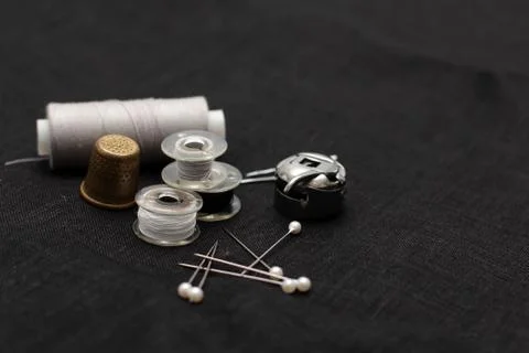 Tools and accessories for sewing on a background of linen fabric Stock Photos