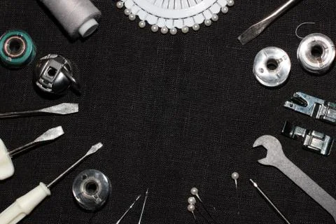 Tools and accessories for sewing on a background of linen fabric Stock Photos