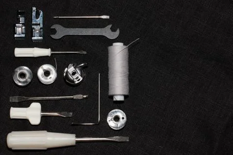 Tools and accessories for sewing on a background of linen fabric Stock Photos