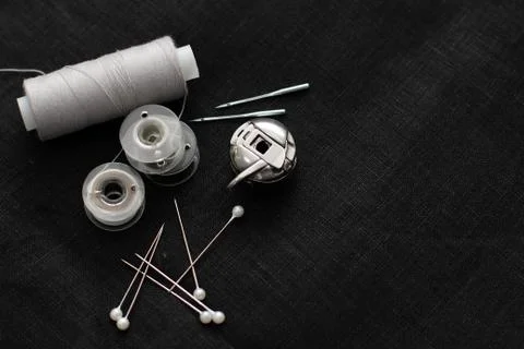 Tools and accessories for sewing on a background of linen fabric Stock Photos