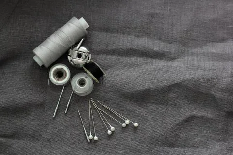 Tools and accessories for sewing on a background of linen fabric Stock Photos