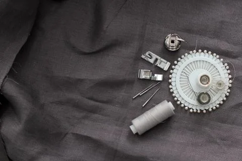 Tools and accessories for sewing on a background of linen fabric Stock Photos