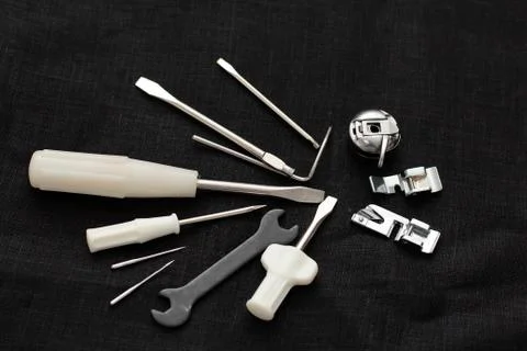 Tools and accessories for sewing on a background of linen fabric Stock Photos