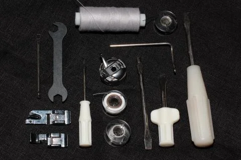 Tools and accessories for sewing on a background of linen fabric Stock Photos