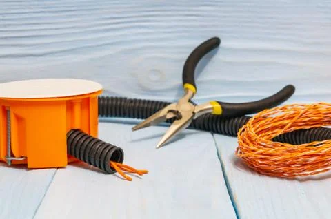 The tools and accessories used in electrical installation or repair on blue w Stock Photos