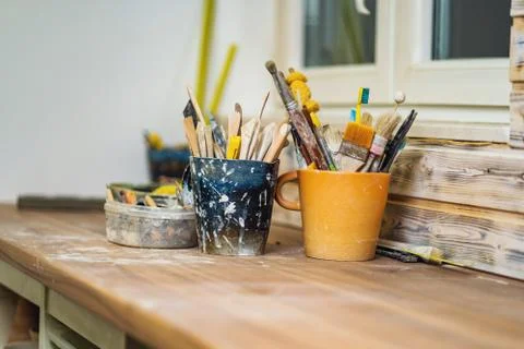 Tools and brushes on pottery studio table Stock Photos