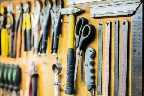 Tools and devices hanging on workshop wall Stock Photos