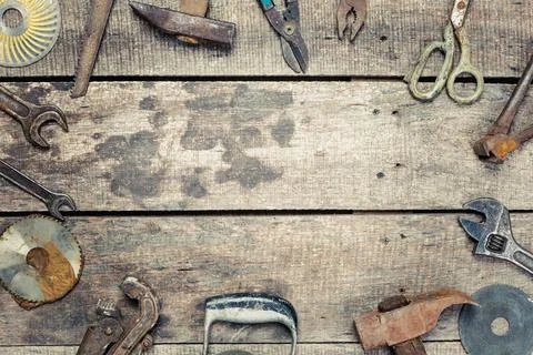 Tools and hardware arranged on a rustic wooden table in a workshop setting Stock Photos