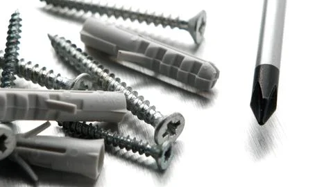 Tools and Hardware Fasteners with Screwdriver on Metallic Surface Stock Photos