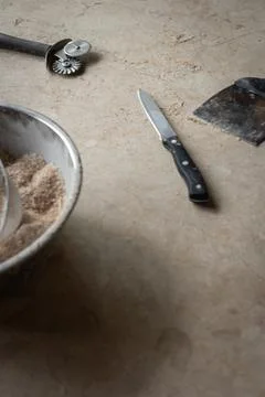 Tools and ingredients for baking bread displayed on a rustic tabletop in a cozy Stock Photos