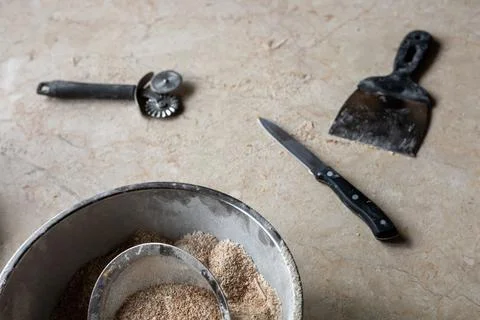 Tools and ingredients for baking bread displayed on a rustic tabletop in a cozy Stock Photos