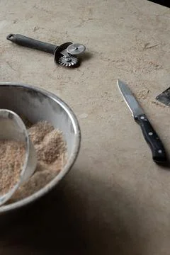 Tools and ingredients for baking bread displayed on a rustic tabletop in a cozy Stock Photos