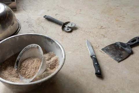Tools and ingredients for baking bread displayed on a rustic tabletop in a cozy Stock Photos