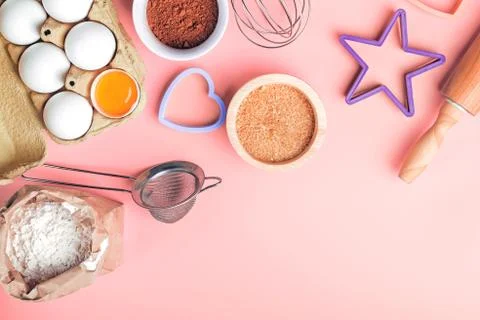 Tools and ingredients for making sweet bakery like pie or cupcakes. Stock Photos