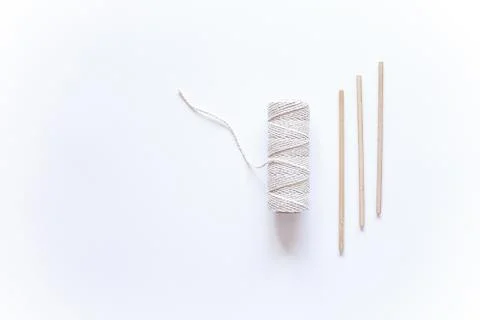 Tools and materials for macrame weaving over white surface. Cotton ropes and  Stock Photos