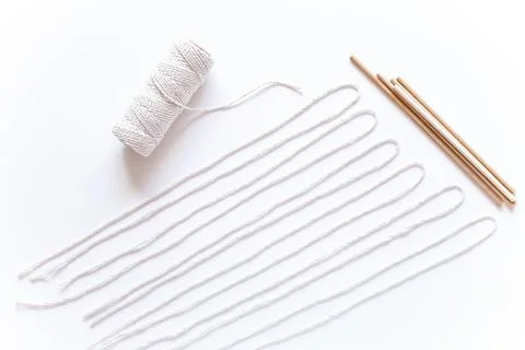Tools and materials for macrame weaving over white surface. Cotton ropes and  Stock Photos