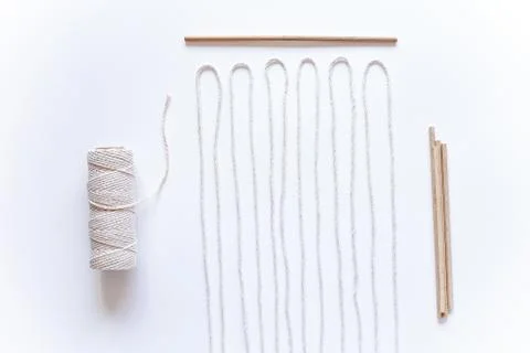 Tools and materials for macrame weaving over white surface. Cotton ropes and  Stock Photos