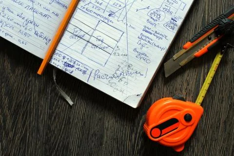 Tools and notebook on wood background. Stock Photos