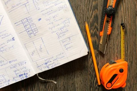 Tools and notebook on wood background. Stock Photos