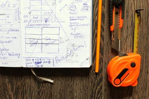 Tools and notebook on wood background. Stock Photos