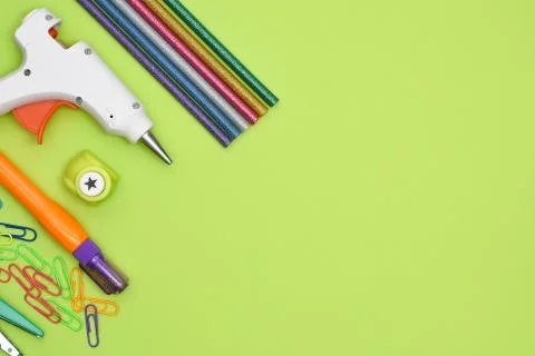 Tools and stationery items for creativity on green background. Stock Photos