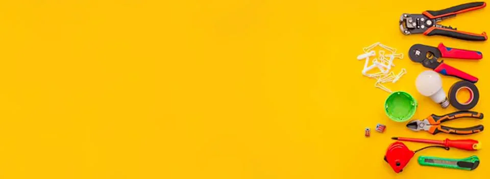 Tools and supplies for electrical work on a yellow background Stock Photos
