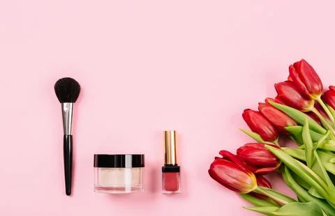 Tools for applying light refreshing makeup lie on a pink background with a .. Stock Photos