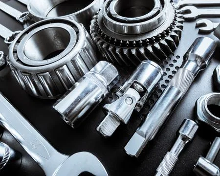Tools arranged neatly on a dark surface showcasing various mechanical parts and Stock Photos