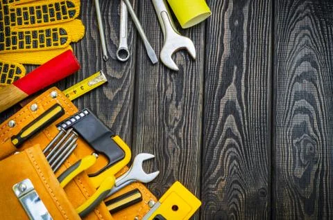 Tools in the bag for carpentry and accessories on a wooden black vintage back Stock Photos