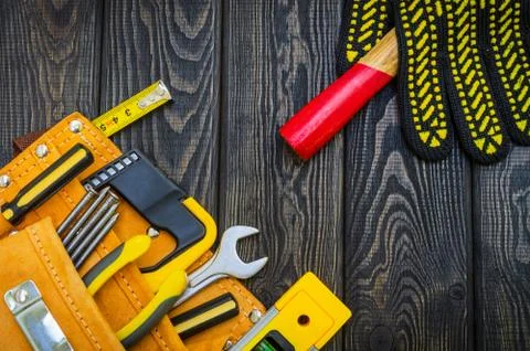 Tools in the bag for carpentry and accessories on a wooden black vintage back Stock Photos