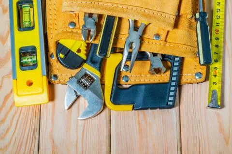 Tools in the bag for master builder on a wooden vintage background Stock Photos