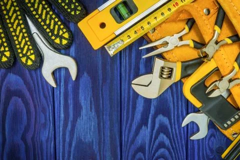 Tools in the bag for master prepared before work on a blue wooden boards Stock Photos