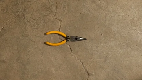 Tools being placed in frame on concrete Stock Footage 121008715