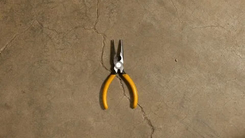 Tools being placed in frame on concrete Stock Footage 121009020