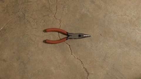 Tools being placed in frame on concrete Stock Footage 121009023