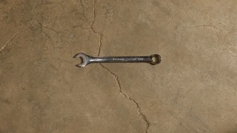 Tools being placed in frame on concrete Stock Footage 121009100