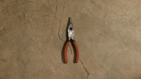Tools being placed in frame on concrete Stock Footage 121009106