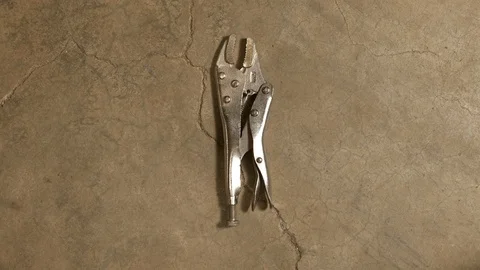 Tools being placed in frame on concrete Stock Footage 121009292