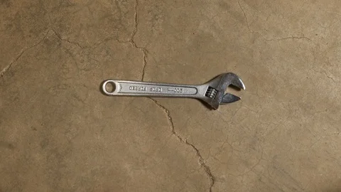 Tools being placed in frame on concrete Stock Footage 121009314