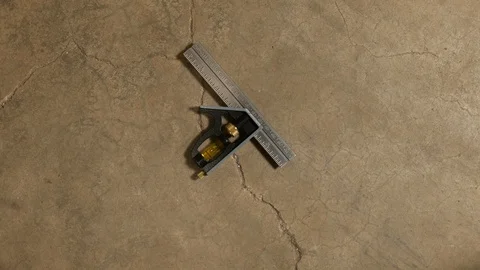 Tools being placed in frame on concrete Stock Footage 121009616