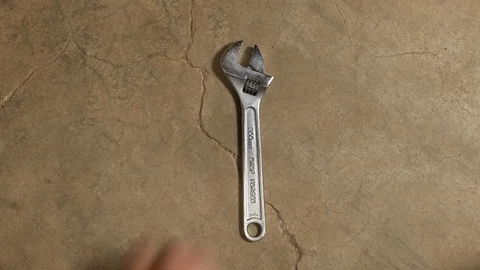 Tools being placed in frame on concrete Stock Footage 121009627