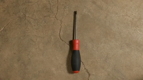 Tools being placed in frame on concrete Stock Footage 121010388